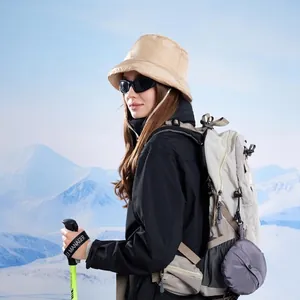 Winter padded warm bucket hat with ear flaps shown in outdoor hiking snowy scenery