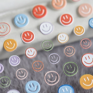 Vibrant 5D self-adhesive nail art stickers with colorful smiley face designs