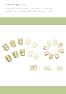 Detail view of mint green false nails set with glitter sequins and sparkling rhinestones