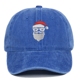Detail of Santa Claus embroidery on washed royal blue vintage cotton baseball cap