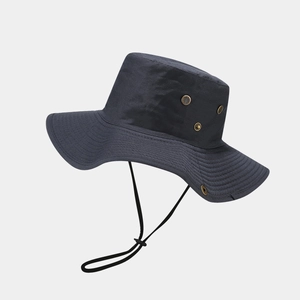 Detail of wide brim sun hat featuring metal ventilation eyelets and adjustable wind strap