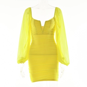 Macro detail of deep V-neckline and ruched texture on bright yellow mini dress