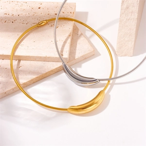 Elegant gold and silver titanium steel round necklaces displayed on beige stone background