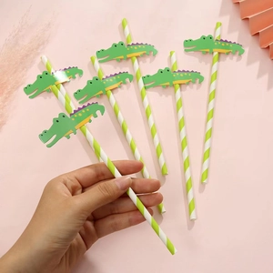 Detail of green striped paper straws with cute crocodile paper cutouts for parties