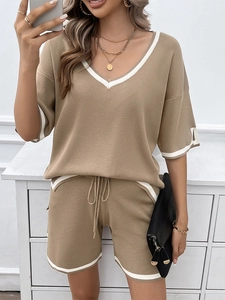 Detail of khaki knit lounge set with V-neck top, drawstring shorts, and white contrast trim