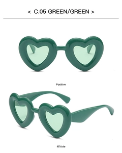 Detail view of heart-shaped green sunglasses model C.05 with matching green lenses