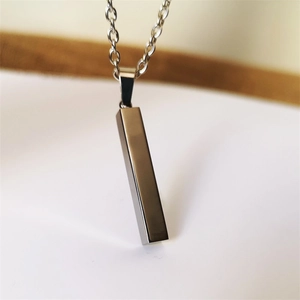 Macro shot of polished silver rectangle bar pendant necklace with sleek metallic finish