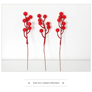 Close-up of three artificial red berry stems for Christmas tree floral decoration