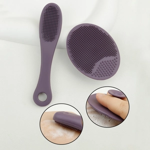 Detail showing purple silicone face brush and finger pad with dense cleansing bristles