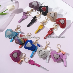 Detailed view of heart rhinestone keychains with tassels and foldable mini tools