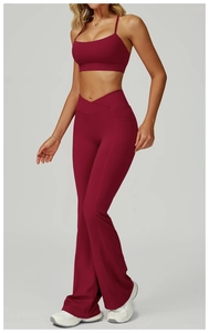 Detail view of burgundy yoga set with cross-waist flare pants and side pockets for fitness