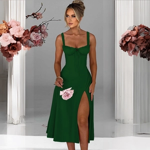 Detail of slim-fit dark green dress with high slit and lace-up neck design