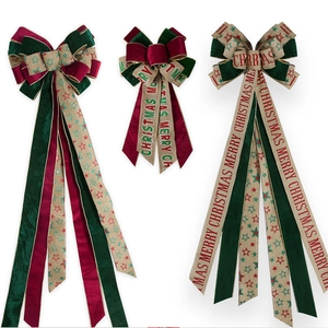 Detail of red and green velvet Christmas bows with Merry Christmas star linen ribbon