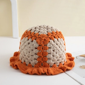 Handmade crochet bucket hat with ruffle brim in beige and orange color-block knit