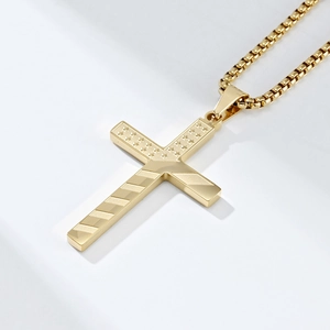 Macro detail of golden cross pendant with American flag pattern and box chain link