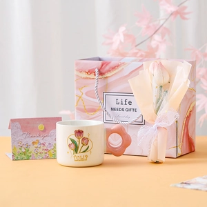 Ceramic tulip mug gift set with pink floral handle, matching gift bag, and greeting card