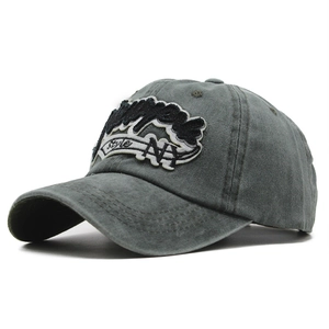 Detail of dark gray washed cotton baseball cap with NY embroidery and vintage style