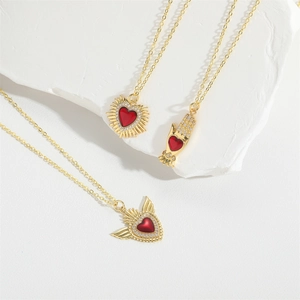 Gold-plated zircon heart necklaces with sun and wing designs on white stone