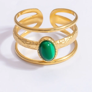Detailed view of adjustable gold-layered bangle with a green oval gemstone and hammered texture