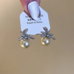 Elegant bow-shaped sterling silver earrings with luxury champagne pearls and cubic zirconia