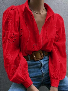 Detail of red hollow-out embroidery and lantern sleeves on a women's casual blouse