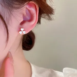 Asymmetric zircon flower stud earrings with gold plating and white shell petals