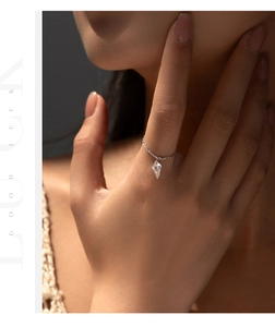 Close-up of s925 silver chain ring with a sparkling geometric diamond pendant