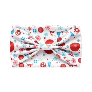 Detail of Christmas headband featuring red reindeer and snowflake patterns on white fabric