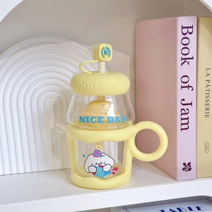 Detail of creative yellow glass straw cup with cute puppy design and sturdy handle