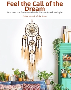 Bohemian large dream catcher with intricate geometric weaving and hanging brown feathers