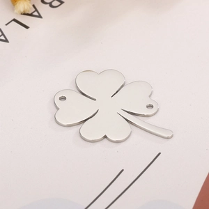 Detail of silver clover metal connector with two holes for DIY jewelry making and craft