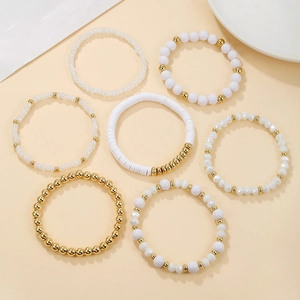 Set of 7 white and gold beaded stretch bracelets with acrylic crystals and clay disks