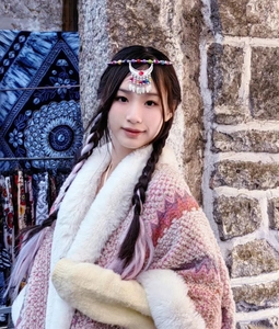 Detailed close-up of ethnic headpiece with colorful beads and faux fur collar texture