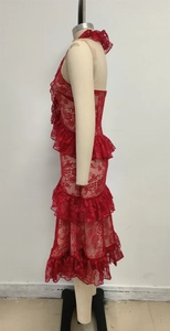 Detail of red lace tiered skirt with ruffled neckline and elegant sleeveless design