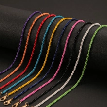Detailed close-up of colorful CZ stone cross pendants in 10 vibrant metal chain shades