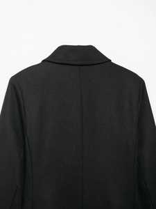 Detail of the high-quality black wool blend fabric with twill texture and stitching