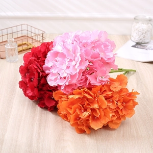 Detailed view of artificial hibiscus roses in red, pink, and orange for home decor