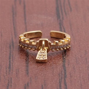Golden zipper padlock open ring with zircon embellishments on dark wood background