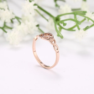 Macro shot of rose gold Celtic knot ring with intricate geometric cutouts and polished finish