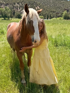 Detail of smocked bodice and tiered A-line skirt on a yellow summer vacation dress