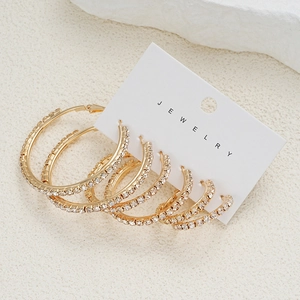 Lot de trois paires de créoles dorées ornées de strass blancs en tailles variées