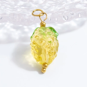 Macro detail of a glass pineapple pendant with gold loop for DIY jewelry making