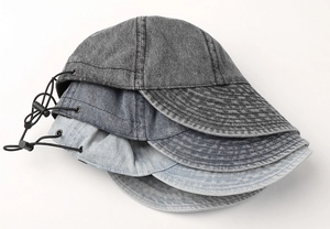 Detailed close-up of denim outdoor hats featuring adjustable drawstrings and topstitching