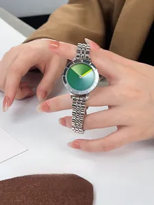 Detail of creative green gradient watch face with minimalist yellow hand on silver steel band