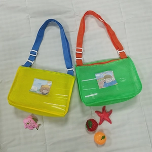 Detail of colorful mesh beach bags with adjustable straps and cartoon front pockets