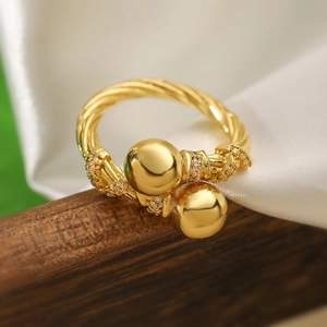Detail of 18K gold plated copper ring with woven texture and sparkling zircon stones