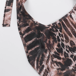 Close-up detail of leopard print fabric with high-quality stitching on halter jumpsuit