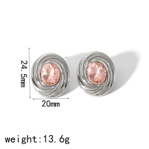 Detailed close-up of silver-tone stud earrings with pink zircon and spiral textured edges