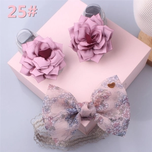 Detailed set of grey baby shoes and pink floral headband with love heart charm