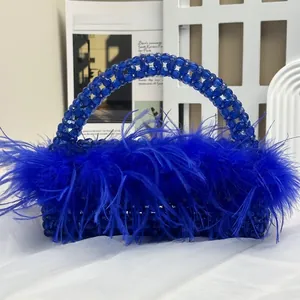 Detail of royal blue beaded handbag with ostrich feathers and pearl handle